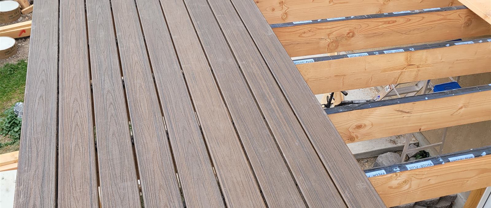 Composite decking installed over flashing-taped joists on a Smart Choice deck build