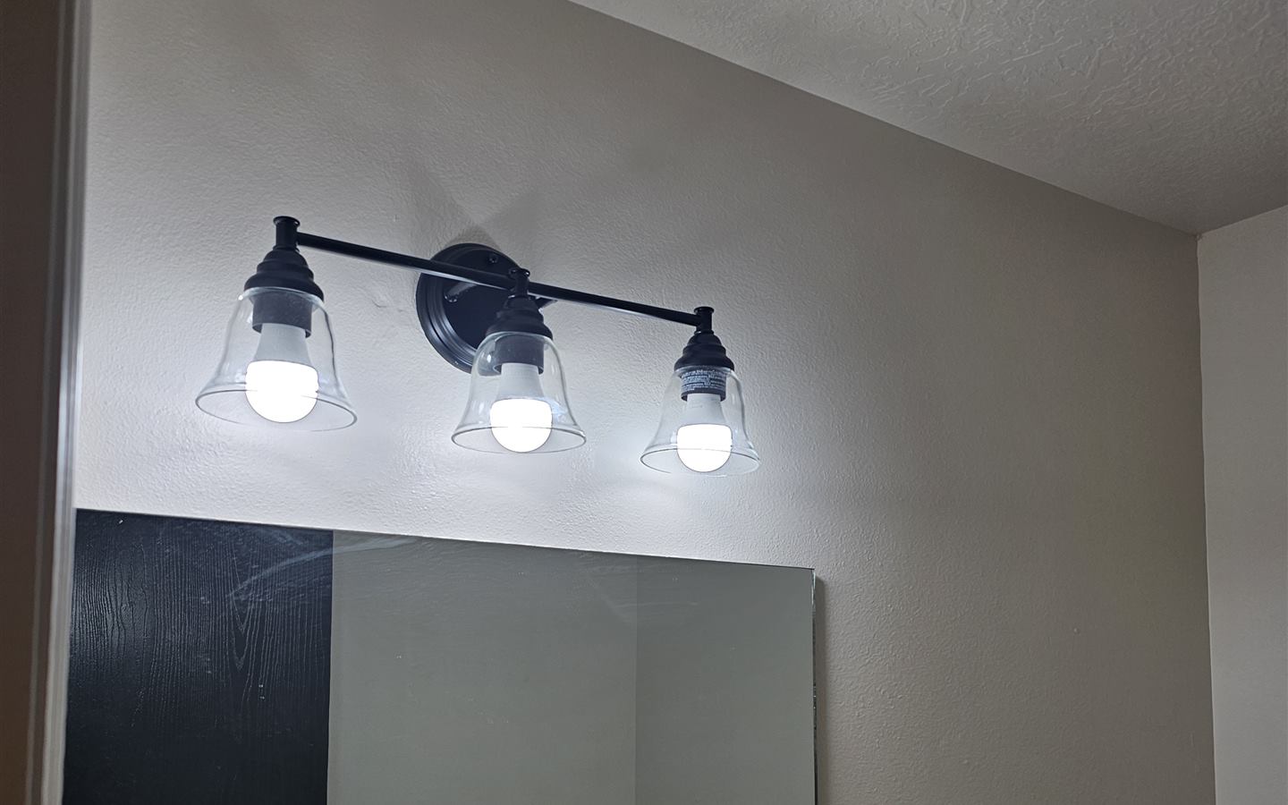 New three-light vanity fixture installed and lit