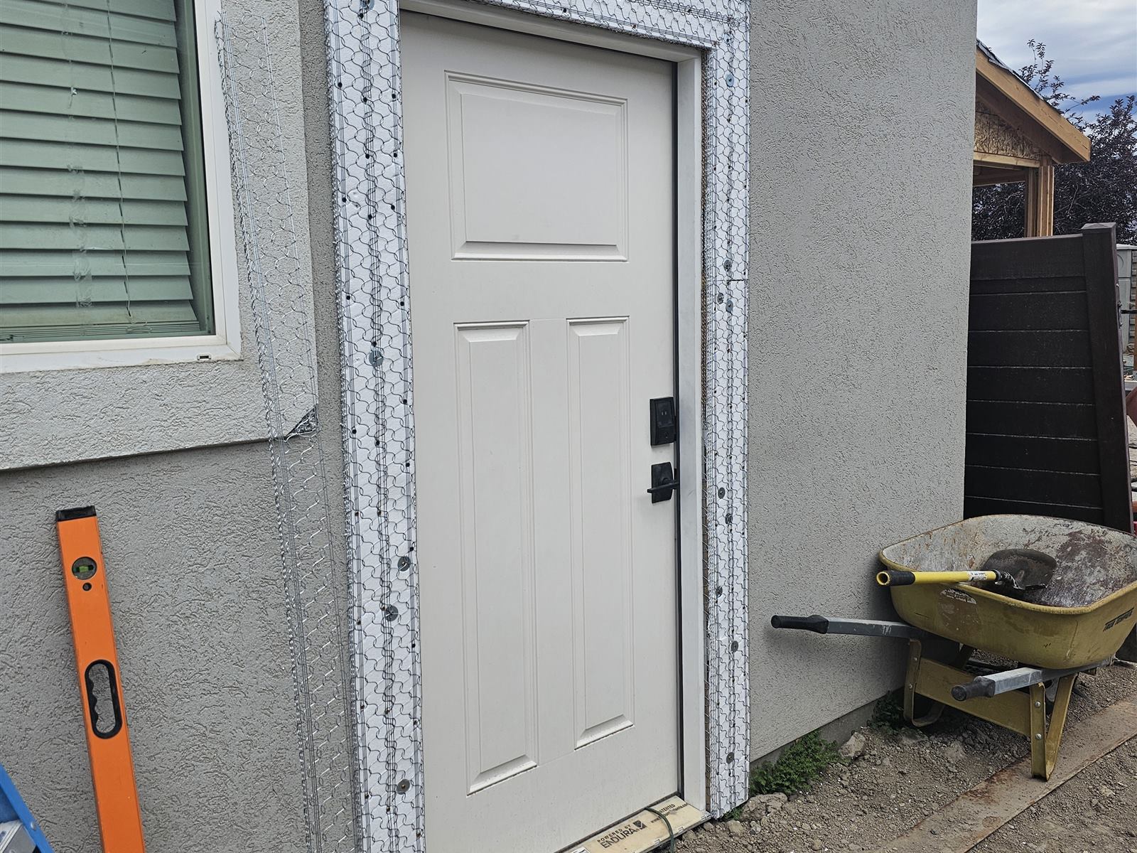 New exterior door hung with wire lath prepped for stucco