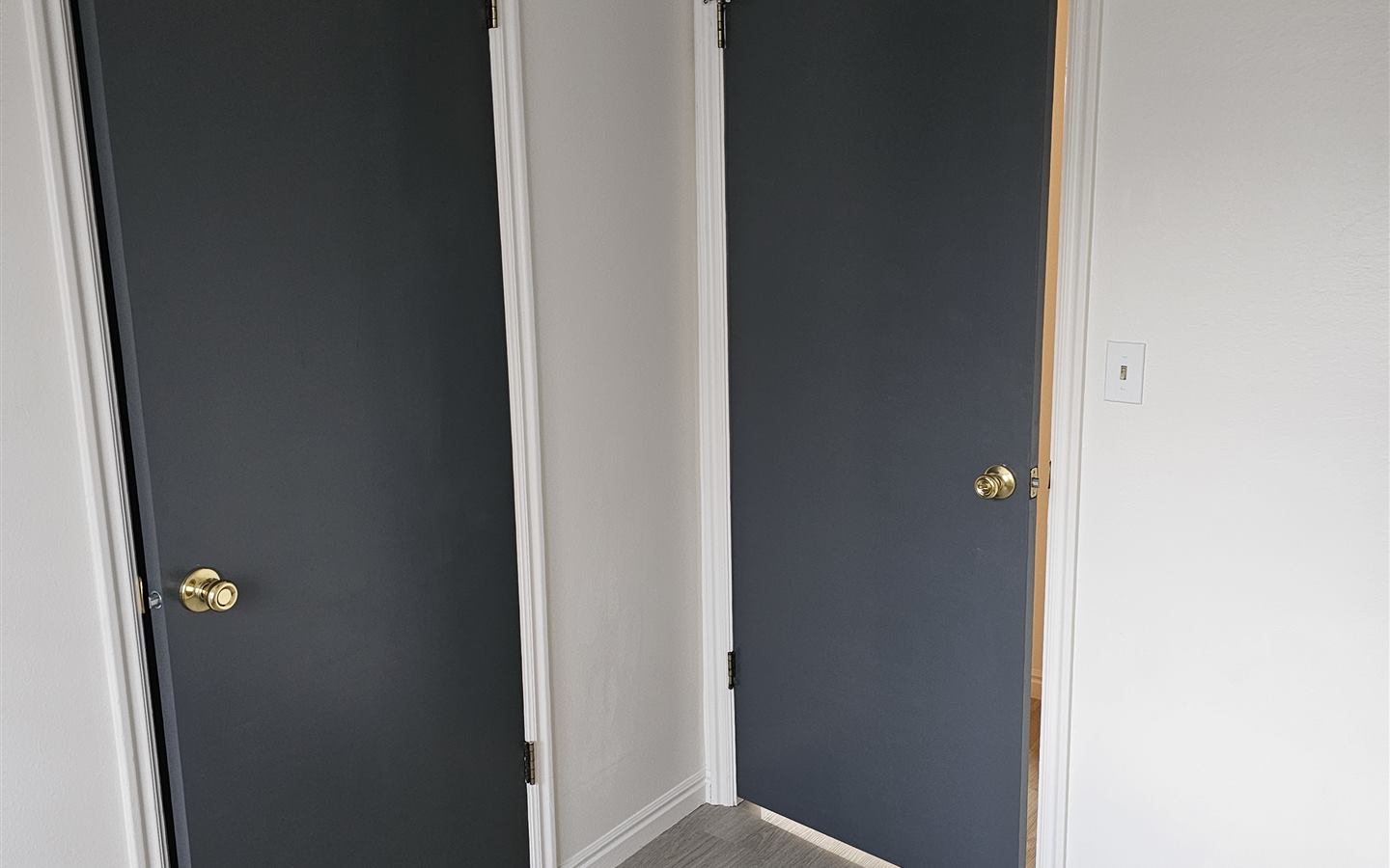 Interior doors painted charcoal with crisp white walls and trim