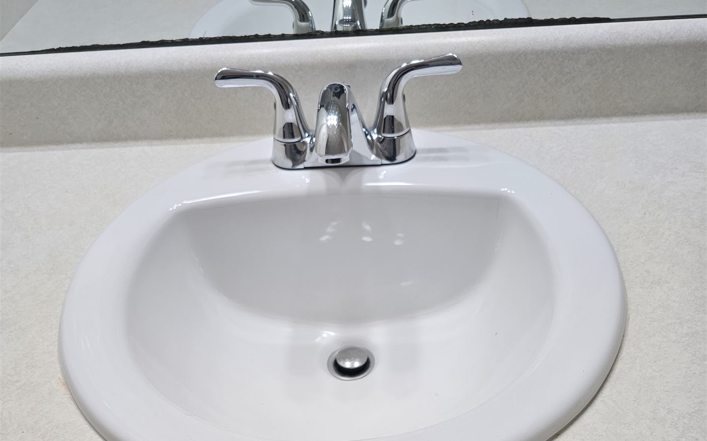 New faucet and sink installed on a refreshed bathroom vanity